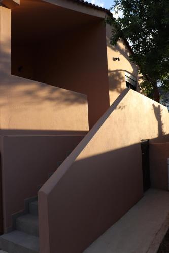 a set of stairs leading up to a building at ALFIEA HOME 65m2 & ALFIEA STUDIO 35m2 in Artemida