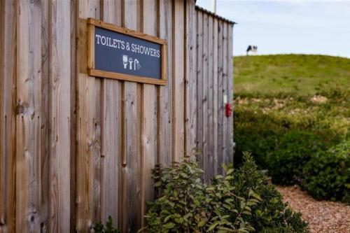 a sign on the side of a wooden fence at 9 Eagles Eyrie, Camp Tapnell in Yarmouth