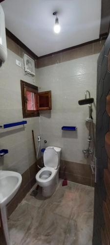 a bathroom with a toilet and a sink at Ikea flat 8 in Hurghada