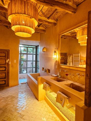 a bathroom with two sinks and a large mirror at CASA ABRACADABRA in Marrakech