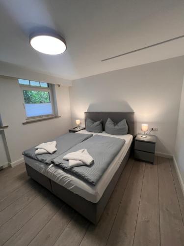 a bedroom with a bed with two towels on it at Ostseehaus Dreesen Souterrain in Timmendorfer Strand