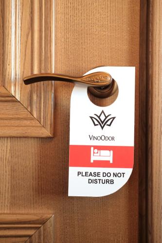 a do not disturb sign on a wooden door at VinoOdor - ვინოოდორ in Tʼelavi