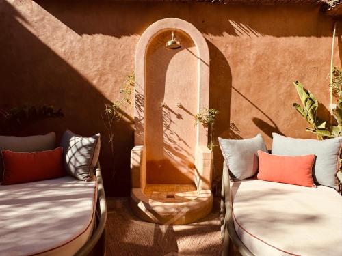 two beds sitting next to a mirror on a patio at CASA ABRACADABRA in Marrakech