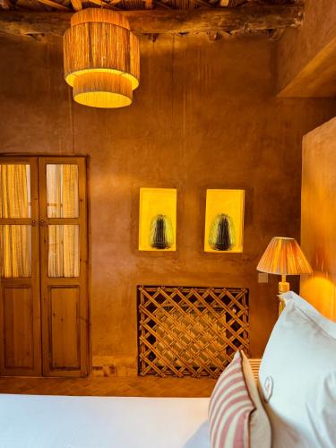 a room with a wooden wall and a door and a lamp at CASA ABRACADABRA in Marrakech