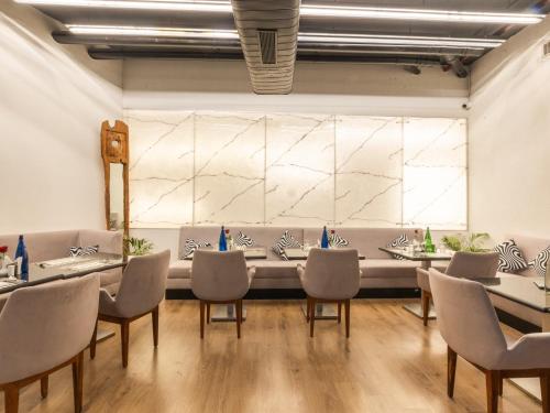a dining room with a long table and chairs at Sunday Hotel Chandigarh Zirakpur in Zirakpur