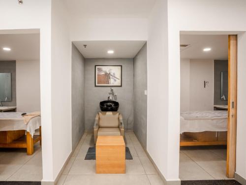 a hallway with a room with two beds at Sunday Hotel Chandigarh Zirakpur in Zirakpur