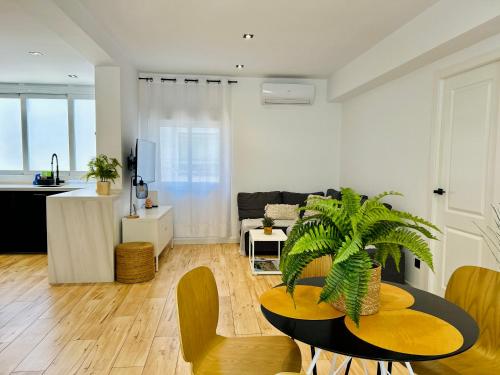 a living room with a table with a plant in it at Ecochic Apartment in Fuengirola Center in Fuengirola