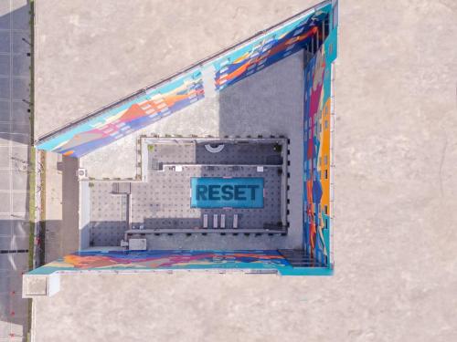 a window in a building with a reset sign on it at Sunday Hotel Chandigarh Zirakpur in Zirakpur
