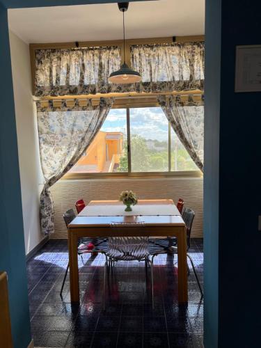 a dining room with a table and a large window at Casamare 83 in Torre Canne