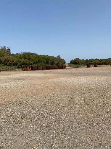 an empty parking lot with trees in the background at Dimidium Apartment in Guspini