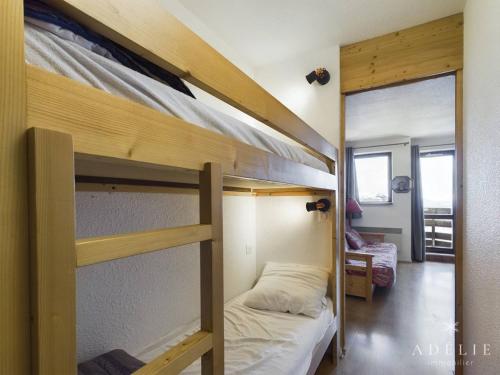 a bedroom with two bunk beds and a mirror at Studio Montvalezan-La Rosière, 1 pièce, 4 personnes - FR-1-398-561 in La Rosière