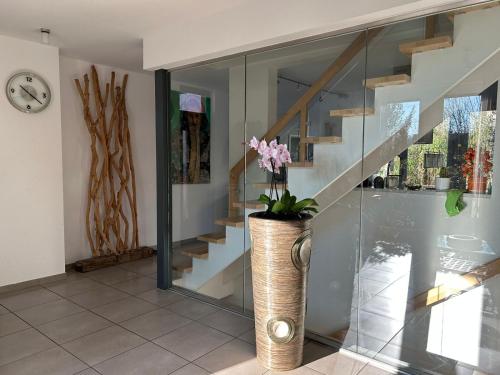 a room with a staircase and a vase with flowers at House Susanne in Cologne