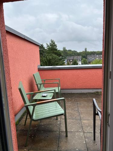 two chairs and a table on a balcony at House Susanne in Cologne