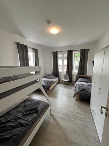 a bedroom with two beds and two beds sidx sidx sidx sidx at City Unterkunft 2 in Heilbronn