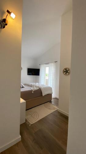 a bedroom with a bed and a window at Villa Milandro - Luxus & Ruheoase in Lašći