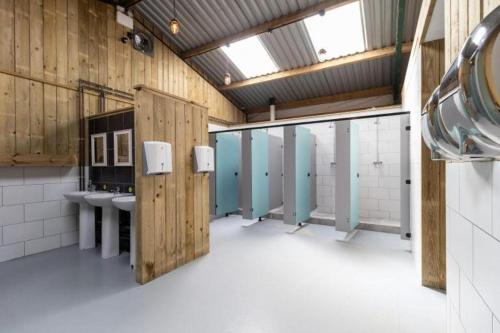 a large bathroom with two sinks and two stalls at 11 Bee Hive, Camp Tapnell in Yarmouth