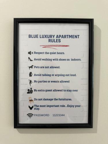 a framed picture of a blue luxury apartment rules sign at Blue Luxury Apartment in Golem