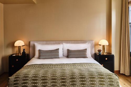 a bedroom with a large bed with two night stands at Downtown Los Angeles Proper Hotel, a Member of Design Hotels in Los Angeles
