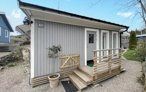 a small shed with a porch and a door at Awesome Home In Grundsund With Wifi in Grundsund