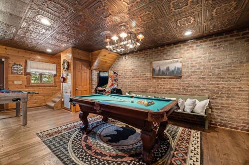 a room with a pool table and a brick wall at Four-Bedroom Holiday Home in Pigeon Forge