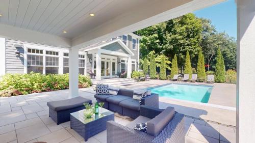 a patio with blue furniture and a swimming pool at Lamb Haven in South Haven