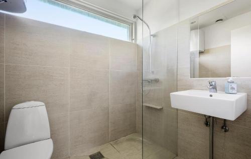 a bathroom with a toilet and a sink and a shower at 3 Bedroom Awesome Home In Vejby in Vejby