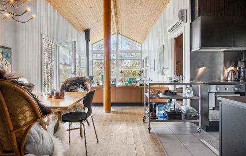a kitchen with a table and a dining room at 4 Bedroom Pet Friendly Home In Strandby in Strandby