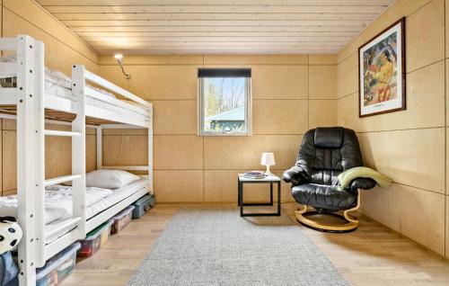 a room with two bunk beds and a chair at Amazing Home In Løgstør With Kitchen in Trend