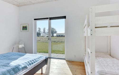 a bedroom with a bunk bed and a sliding glass door at Beautiful Home In Haderslev With Kitchen in Haderslev