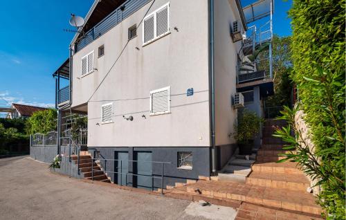 an exterior view of a white building with stairs at 4 Bedroom Lovely Apartment In Krusevo in Kruševo
