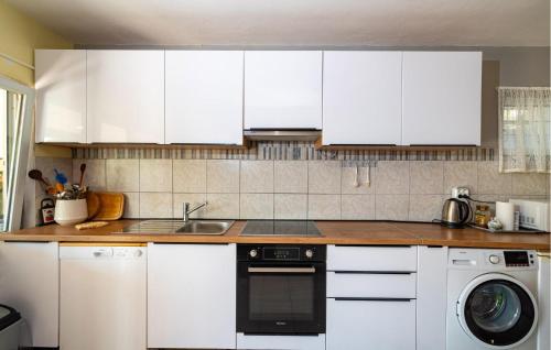 a kitchen with white cabinets and a dishwasher at 4 Bedroom Lovely Apartment In Krusevo in Kruševo