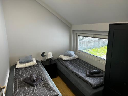 a small bedroom with two beds and a window at Klimatyzowane Apartamenty przy Targach Kielce, Trade Fair in Kielce