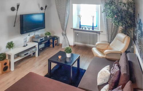 a living room with a couch and a tv at Nice Apartment In Pelm With Wifi in Pelm