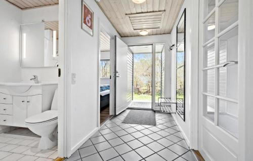 a bathroom with a toilet and a sink at Beautiful Home In Ebeltoft With 4 Bedrooms, Wifi And Indoor Swimming Pool in Ebeltoft