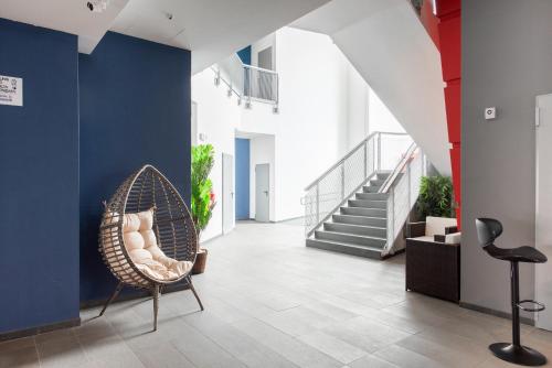 a hallway with a chair and stairs in a building at Ottavia Residence Roma in Rome