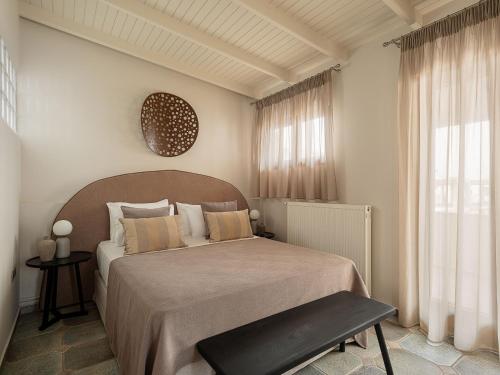 a bedroom with a large bed and a window at Xenios Dias Luxury Apartments With Sea View in Kato Daratso