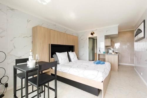 une chambre avec un lit et un bureau dans l'établissement Studio calme et élégant avec vue mer, à Cannes