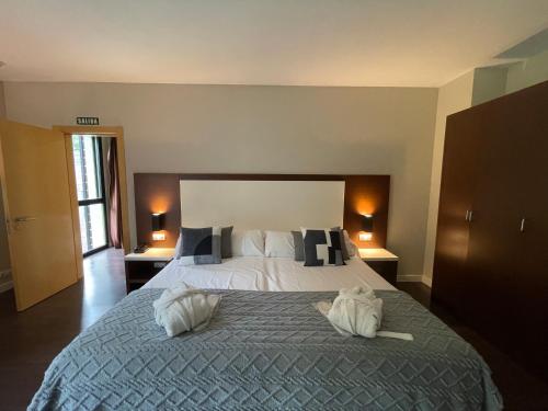 a bedroom with a large bed with two pillows at Balneario Elgorriaga in Elgorriaga