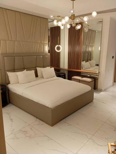 a bedroom with a large bed and a large mirror at Sujimoto Shortlet Ave Forche, Banana Island, Ikoyi in Ikoyi