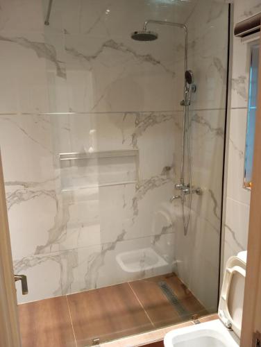 a bathroom with a shower and a sink at Sujimoto Shortlet Ave Forche, Banana Island, Ikoyi in Ikoyi