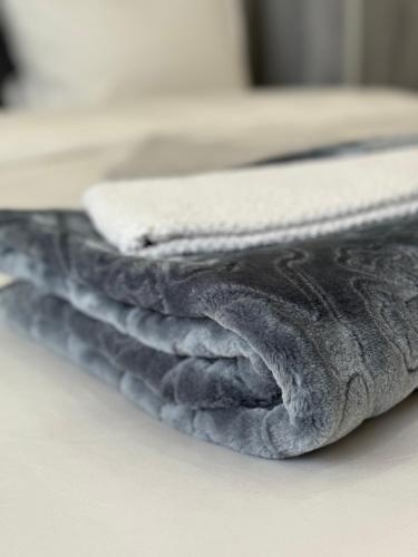 a stack of blue towels sitting on a table at Petra Pillars Way Hostel in Wadi Musa