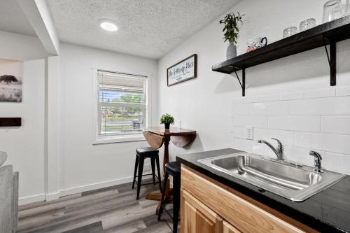 a kitchen with a sink and a table at Peach Street Super Suite in Medford