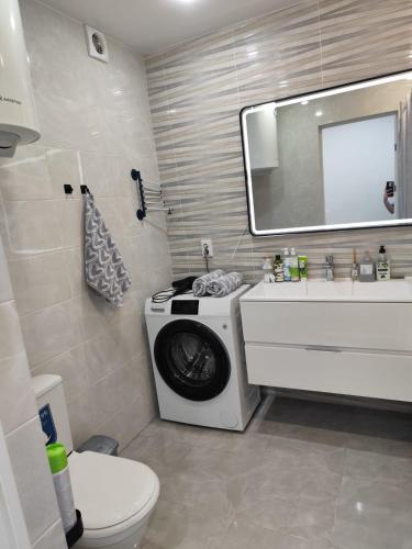 a bathroom with a washing machine and a sink at Квартира Ауэзова 102 Щучинск in Shchūchīnsk