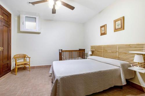 a bedroom with a bed and a ceiling fan at Villa For Families los Agaves in La Cala de Mijas