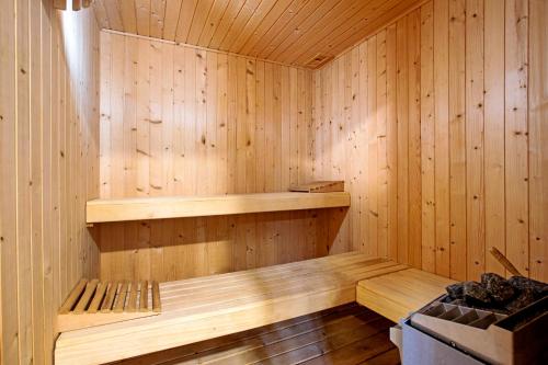 a wooden sauna with a wooden bench in it at Villa For Families los Agaves in La Cala de Mijas