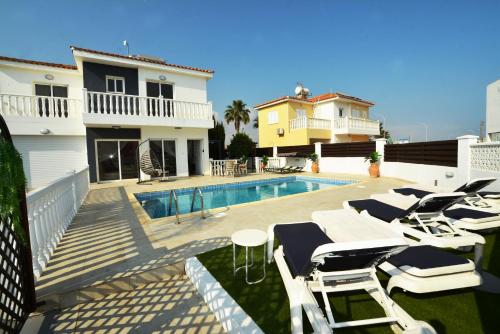 a villa with a swimming pool and a house at Villa Thetida in Ayia Napa