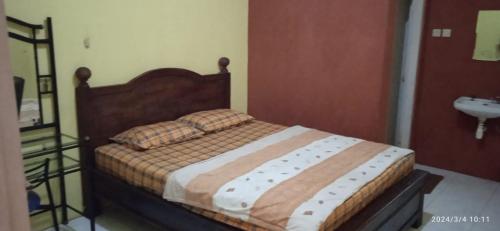 Un pat sau paturi într-o cameră la Istana Griya 1