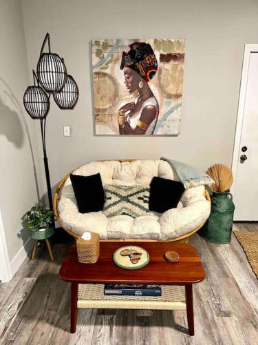 a living room with a couch and a table at Boho Bungalow near TU/DT/Cherry St/Expo Center in Tulsa