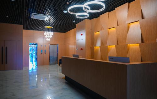 a lobby with a reception desk in a building at New Wave Apart-Hotel in Batumi