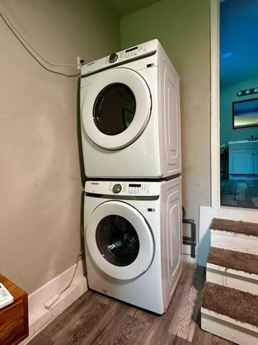 two washing machines stacked on top of each other in a room at Boho Bungalow near TU/DT/Cherry St/Expo Center in Tulsa